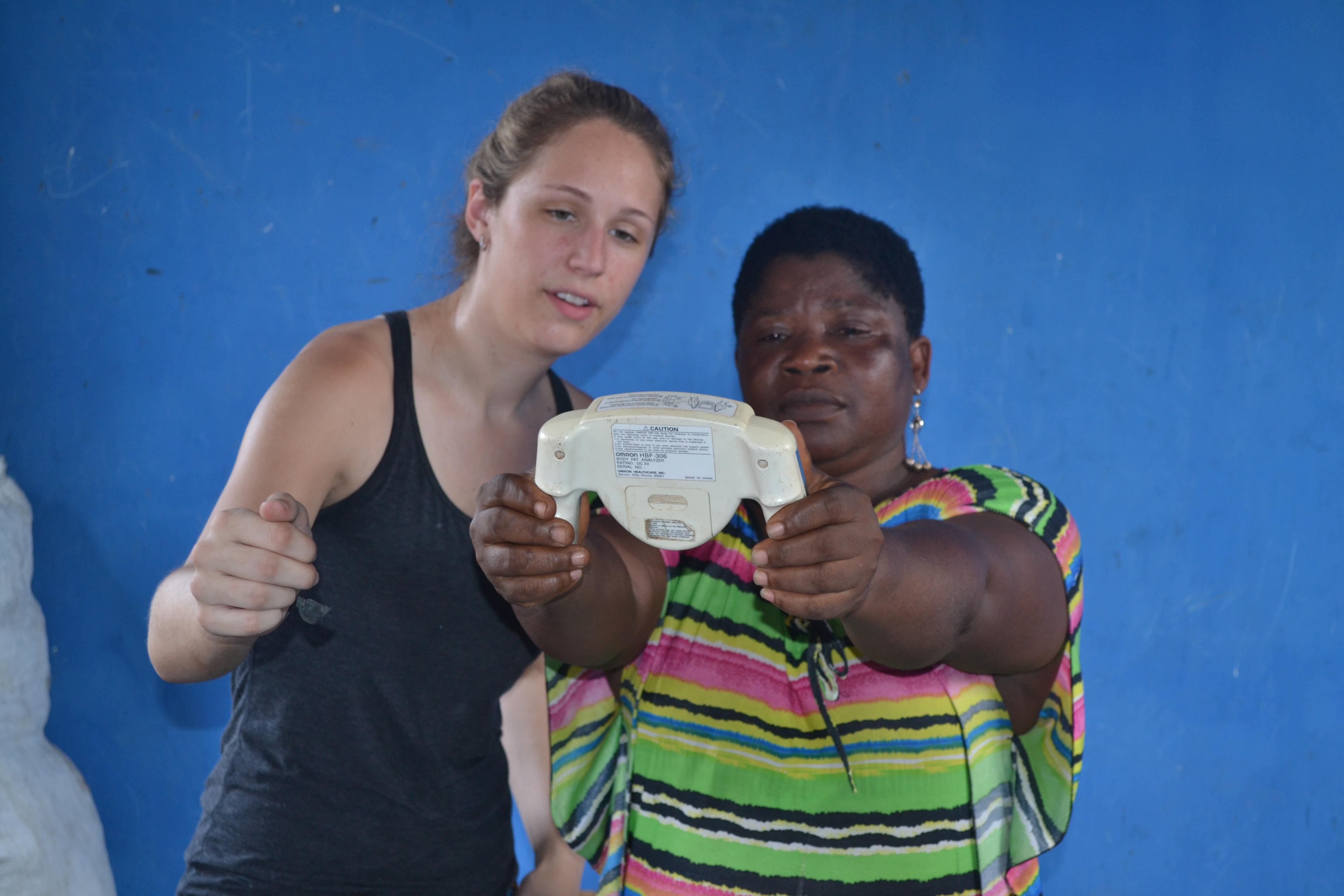 Pasante ayudando a tratar a una ghanesa durante su pasantía de Salud Pública en Ghana. Pasante de salud ayudando a una mujer durante una brigada médica.